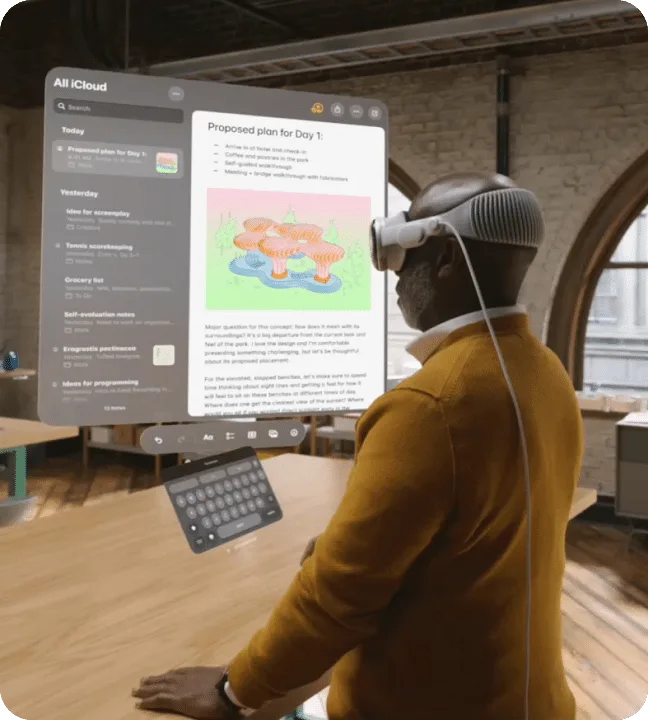 An image of a person wearing an Apple Vision Pro headset. He is viewing a web page floating in augmented reality.